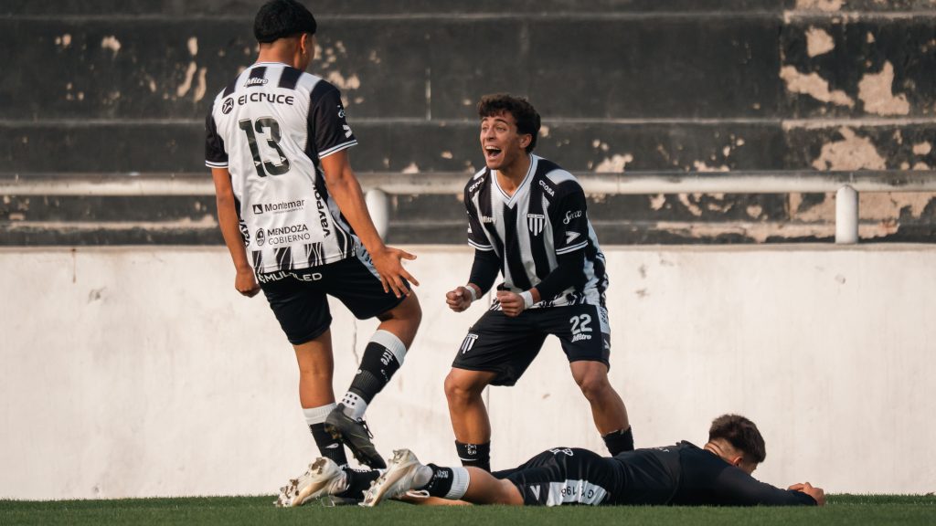 Two football players celebrating a scored goal on the pitch, illustrating the Both Teams to Score betting market