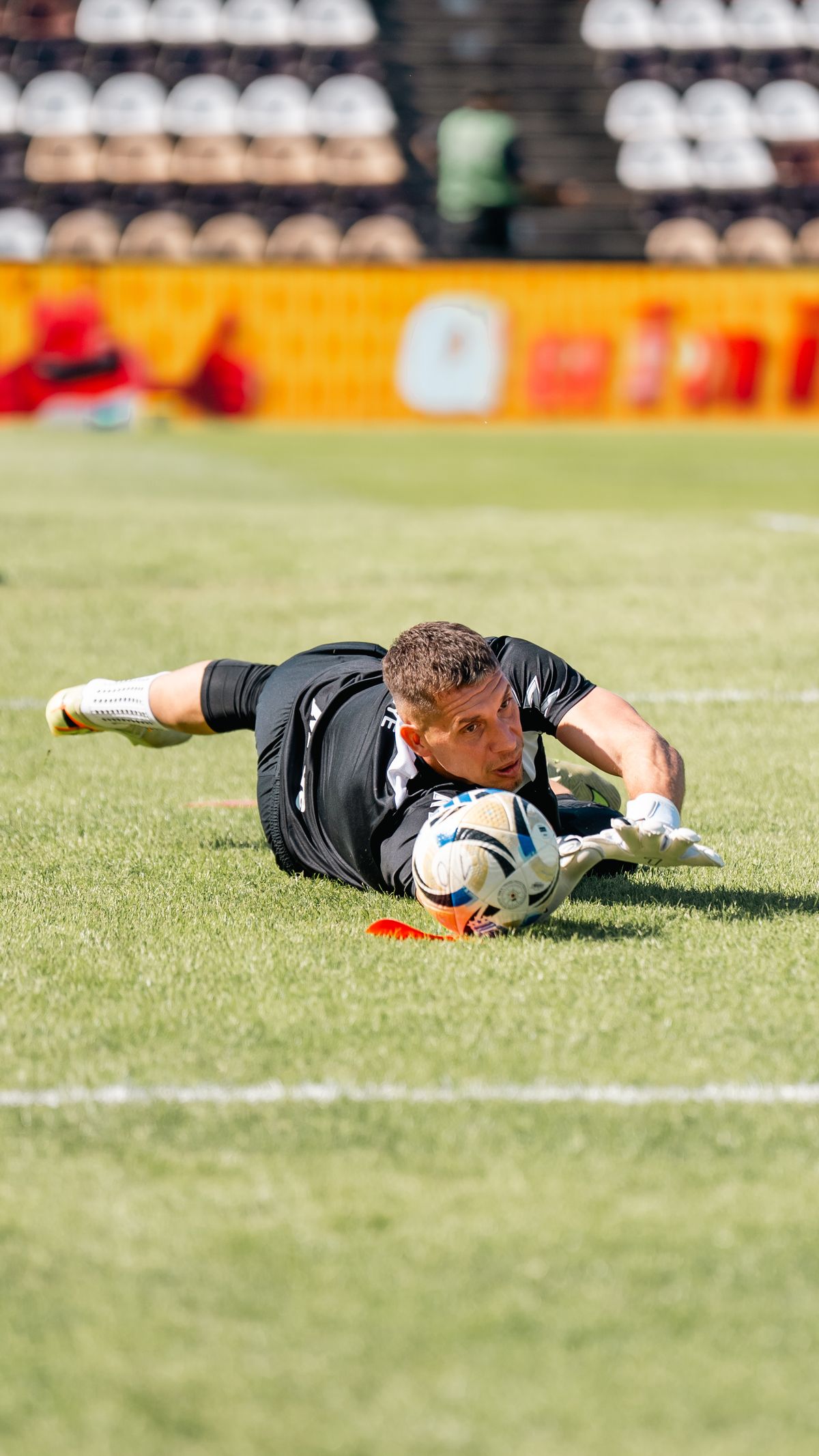 Goalkeeper making a diving save, representing clean sheet betting
