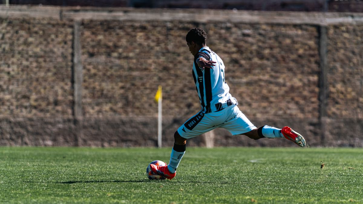 Soccer player kicking the ball during a match, representing player props betting